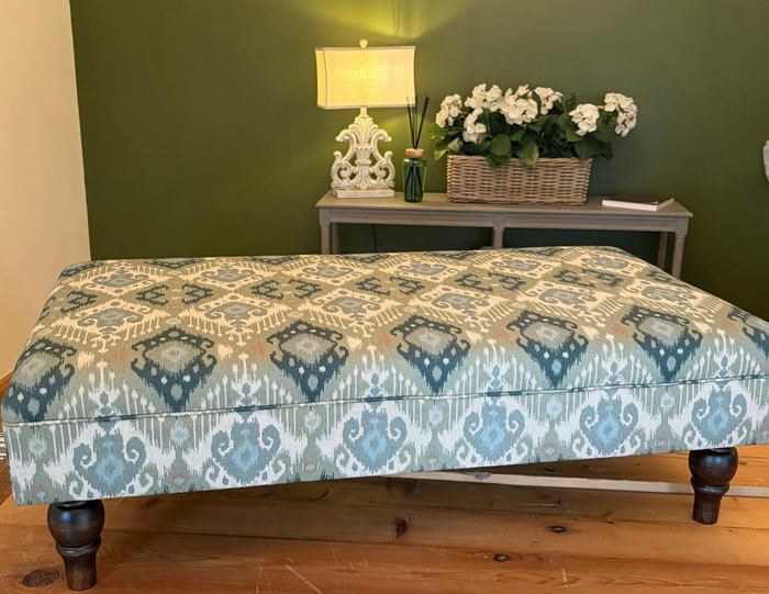 Teal ikat upholstered footstool with turned wooden legs